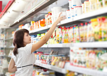 Young woman in the supermarket choose food