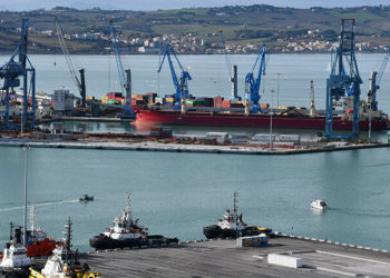 Ancona, Italy - December 15, 2019: Boats, cranes and containers in the Port of Ancona.