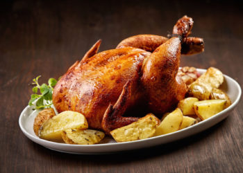 46728157 - roasted chicken and vegetables on wooden table